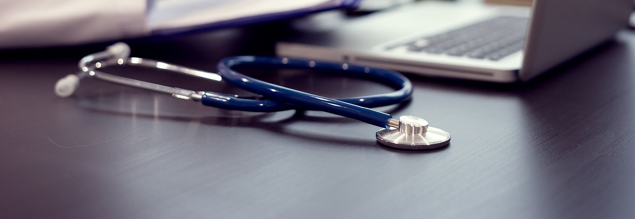 Stethoscope sitting on a desk.