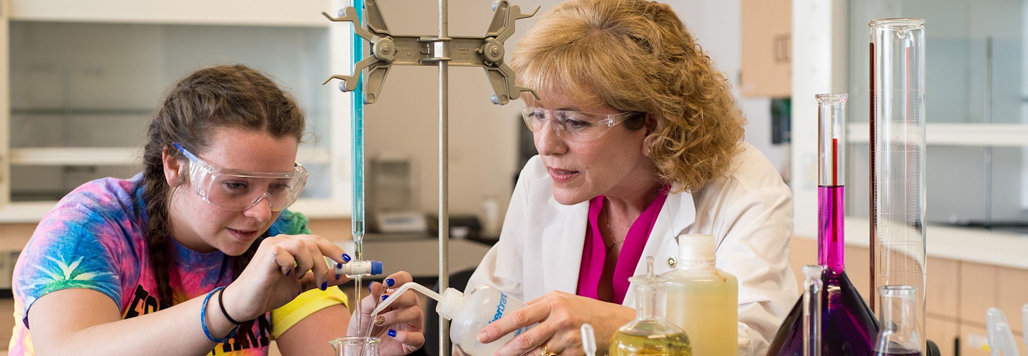 CCU professor helping a student with her lab project. 