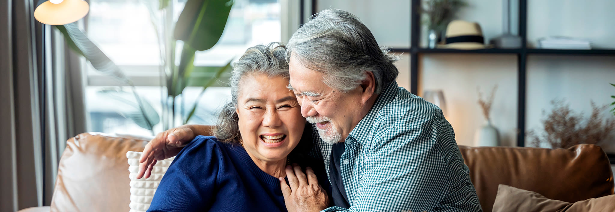 retired couple smiling and embracing each other