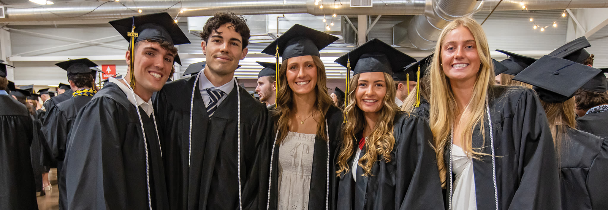ccu graduates smiling at after the commencement ceremony