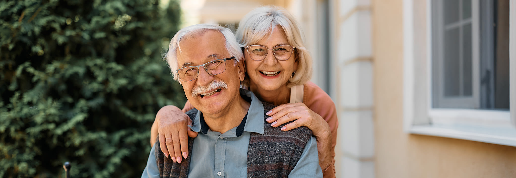 retired couple smiling outside