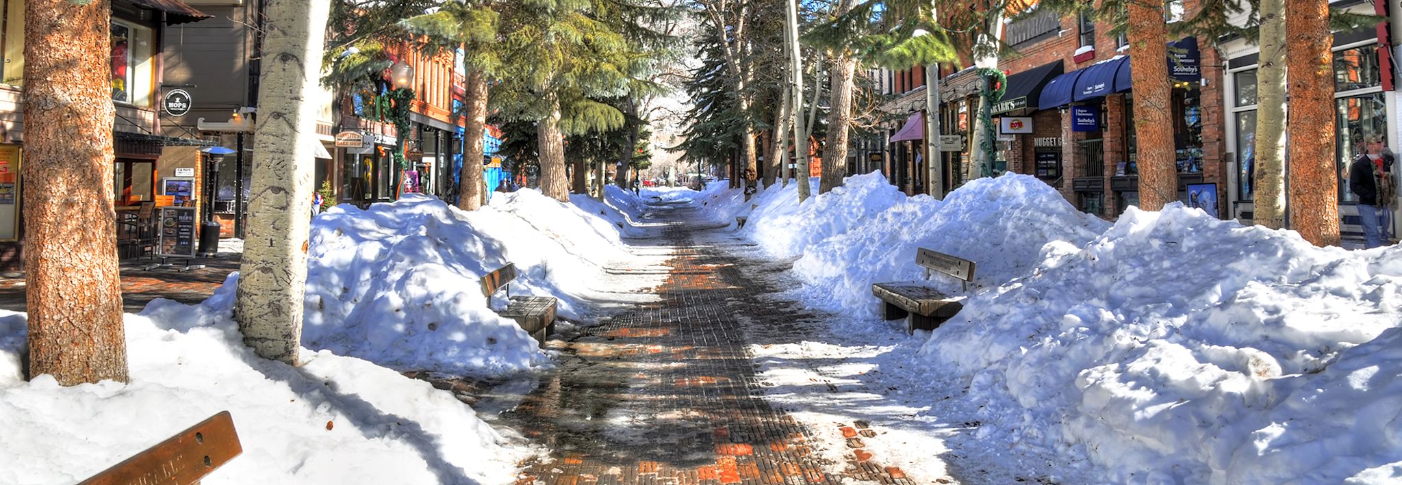 Snow pilled up on the sides of a sidewalk in Aspen, Colorado. 