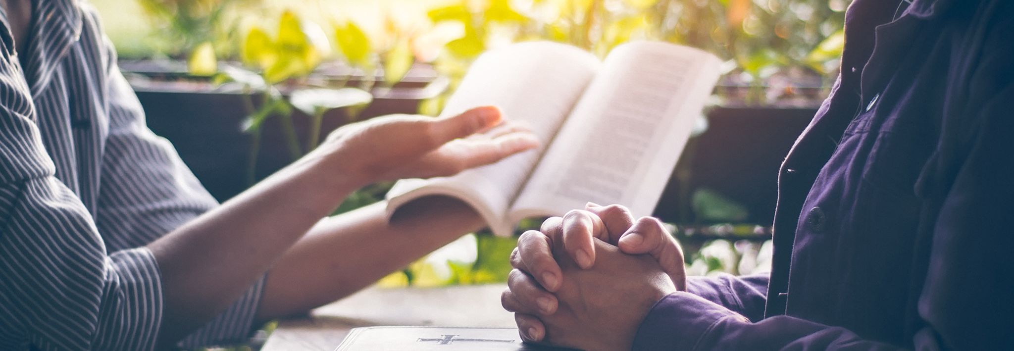 A person teaching his friend about the Bible.