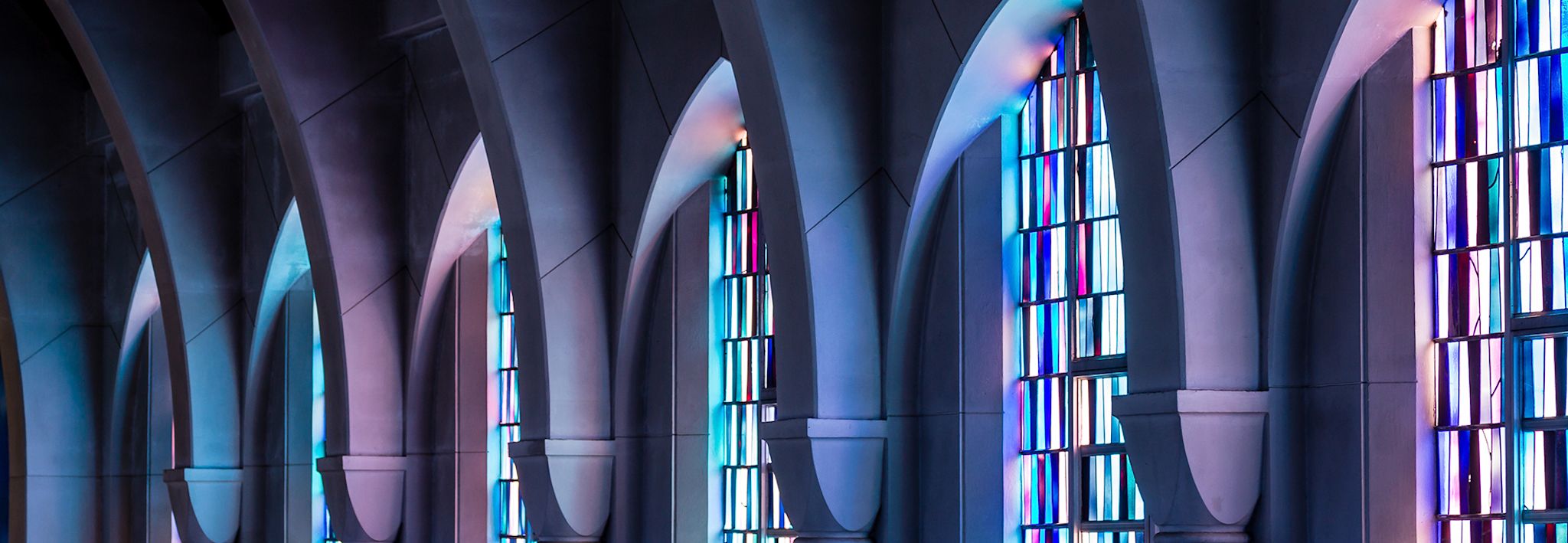 Stained glass windows in a church Church has purple and blue stained glass.