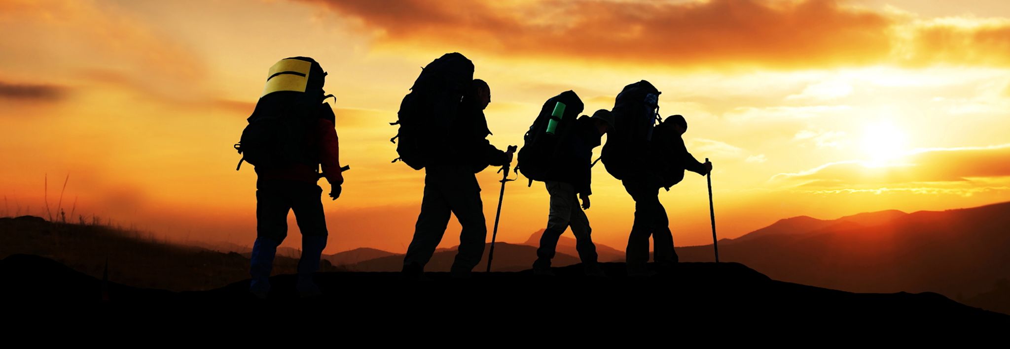 College students hiking at sunset.