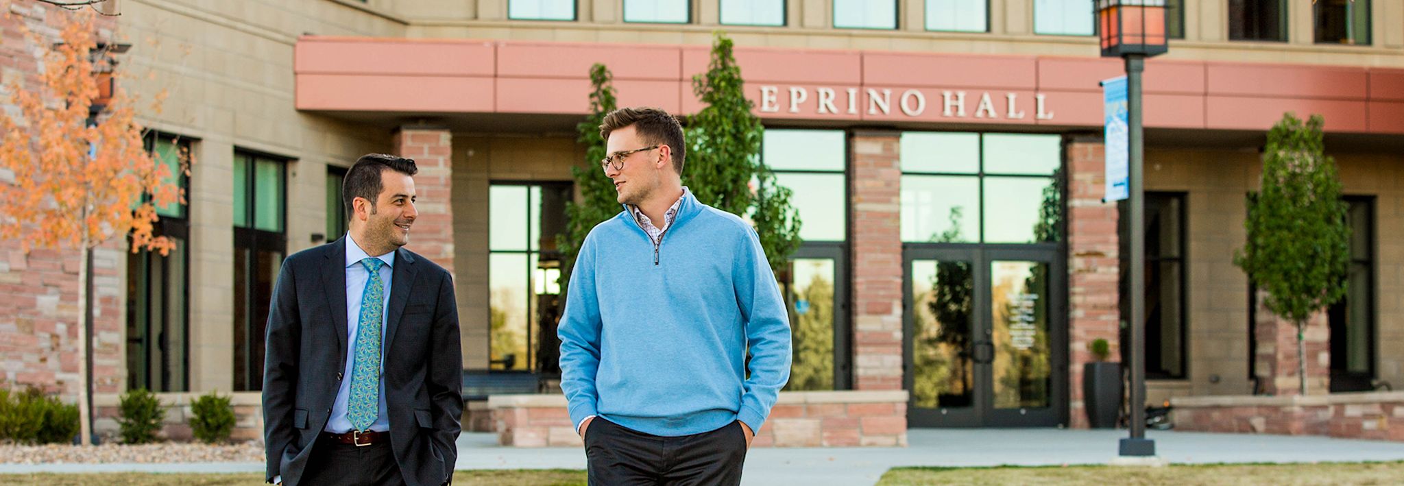 A CCU professor and student having a conversation on CCU's Lakewood campus.