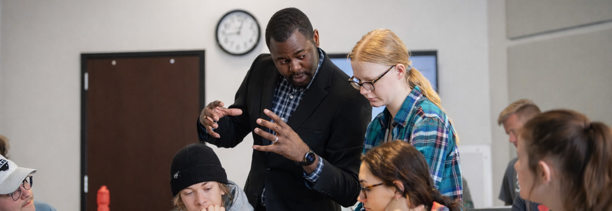 ccu professor speaking with a group of students