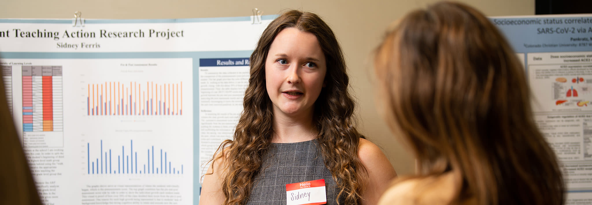 female ccu student presenting research to peers and professors