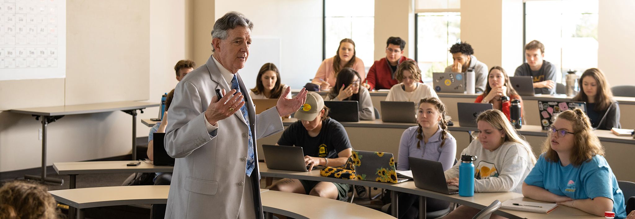 professor teaching a classroom full of interested students at ccu