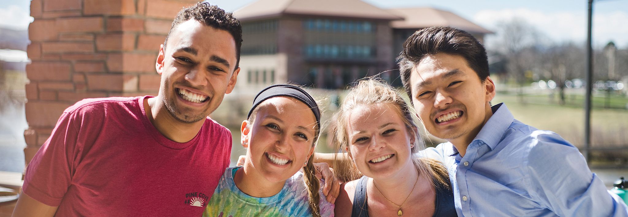 students in the mountains smiling and standing together