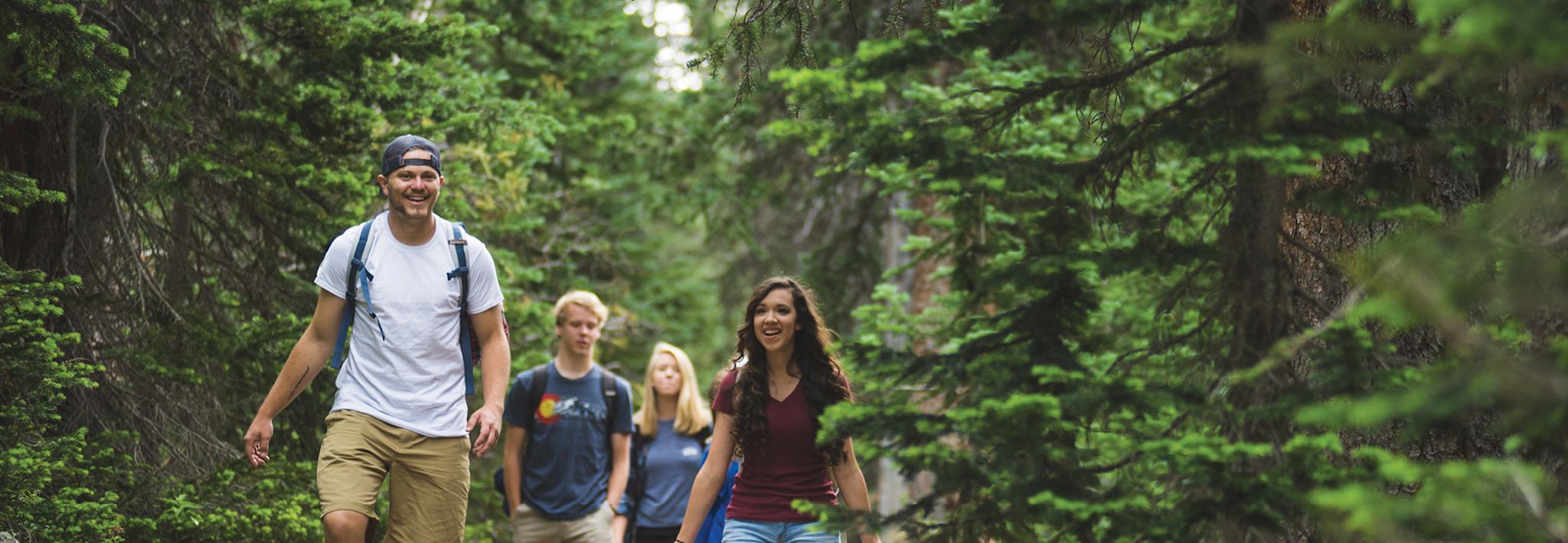 Colorado Christian University students walking through the woods.