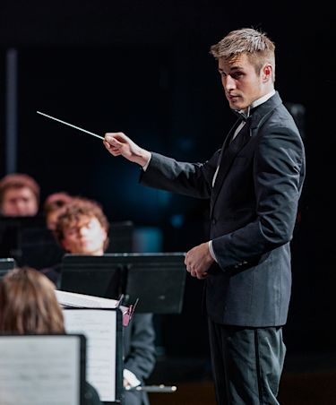 ccu student conductor leading the orchesta in a performance