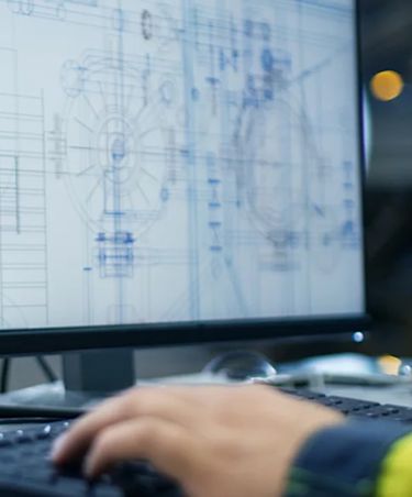 engineer working at a desk on the computer