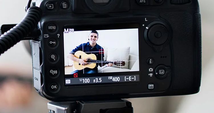 view through a camera recording a guitarist