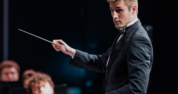 ccu student conductor leading the orchesta in a performance