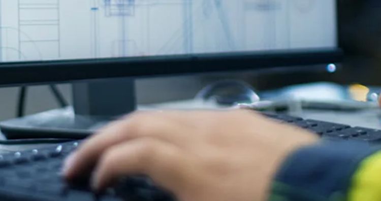 engineer working at a desk on the computer
