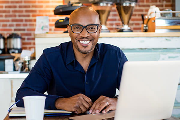 Adult graduate student smiling while studying
