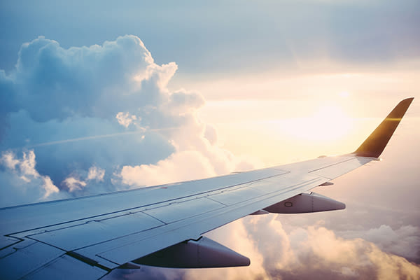 wing of an airplane flying through clouds