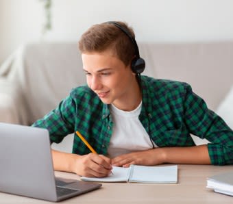 high school boy working on a laptop