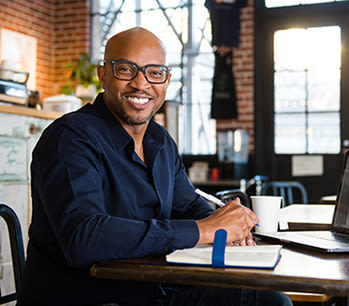 adult graduate student smiling while studying