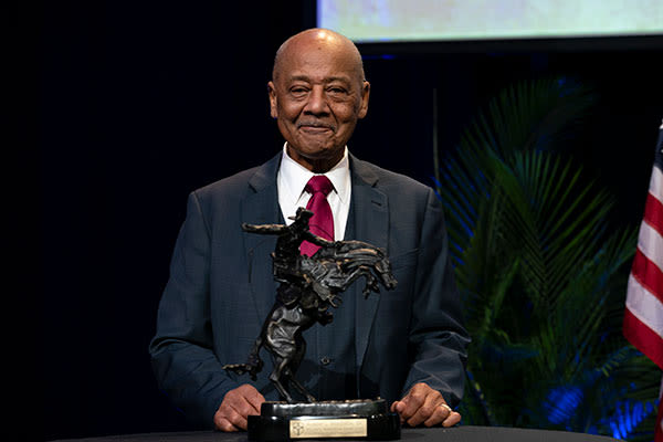 doctor bob woodson holding armstrong award