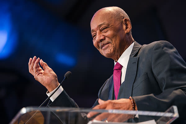 doctor woodson speaking at podium