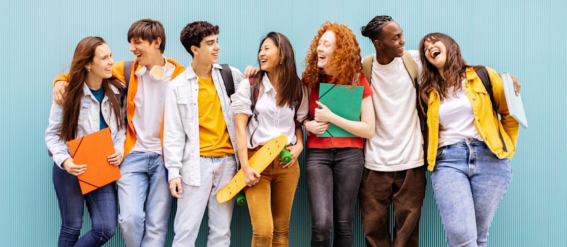 group of high school students dressed in bright colors and smiling (slide 2 of 6)