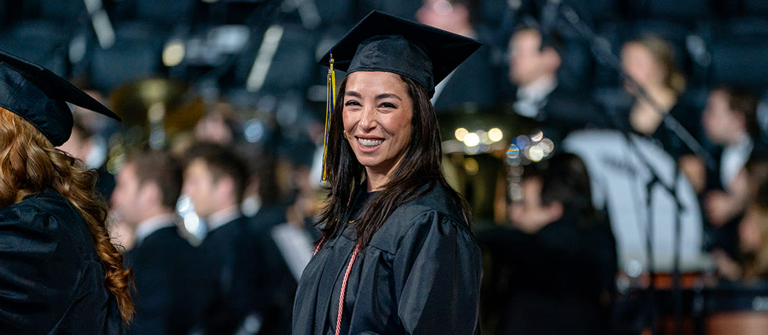 Student smiles as she receives her diploma (slide 4 of 4)