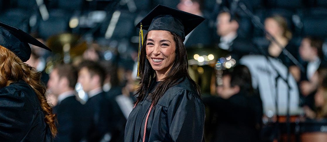 Student smiles as she receives her diploma (slide 6 of 6)