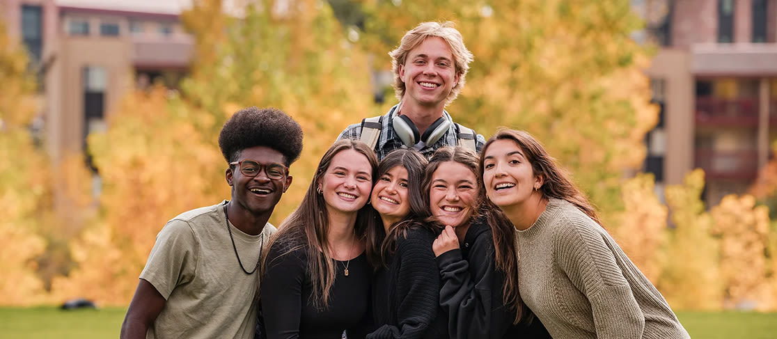 ccu students outside on campus smiling at the camera (slide 5 of 6)