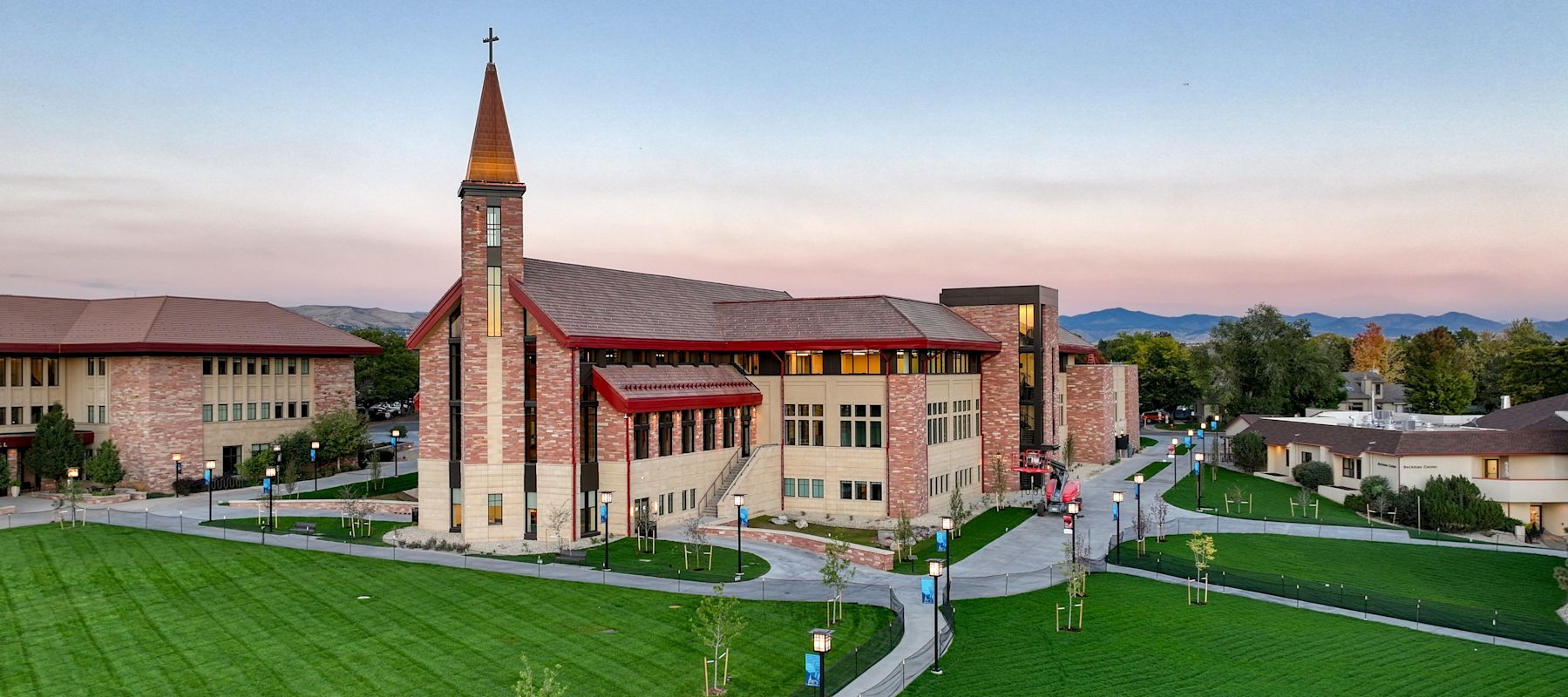 Armstrong Center building as it nears completion, with dark green turf in the foreground.