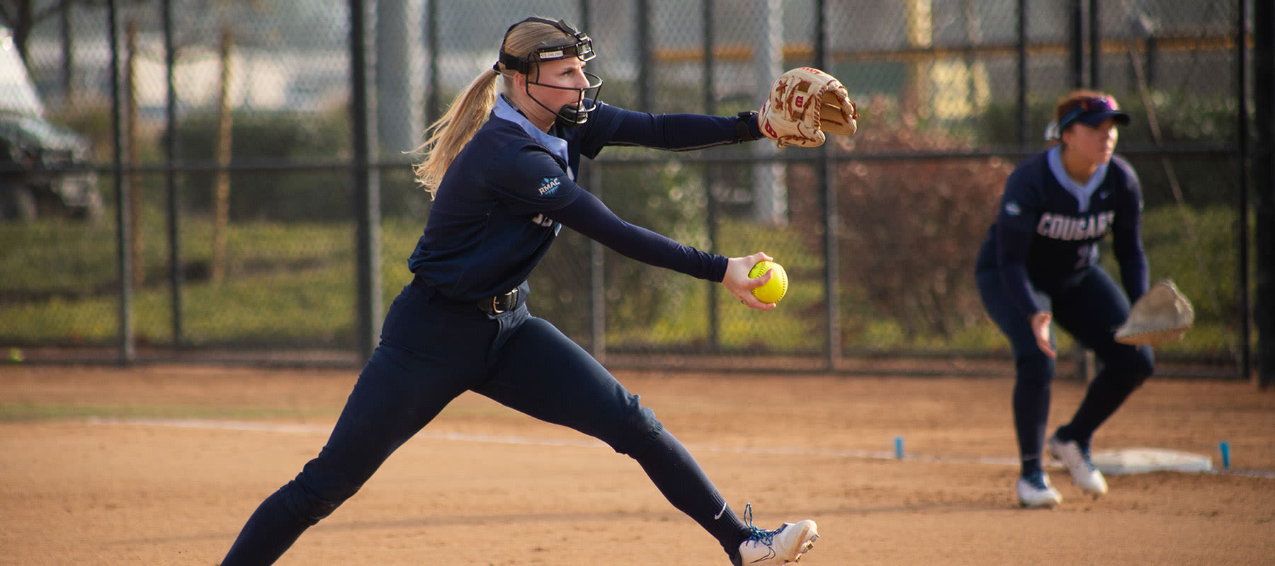 softball player pitching at a ccu game