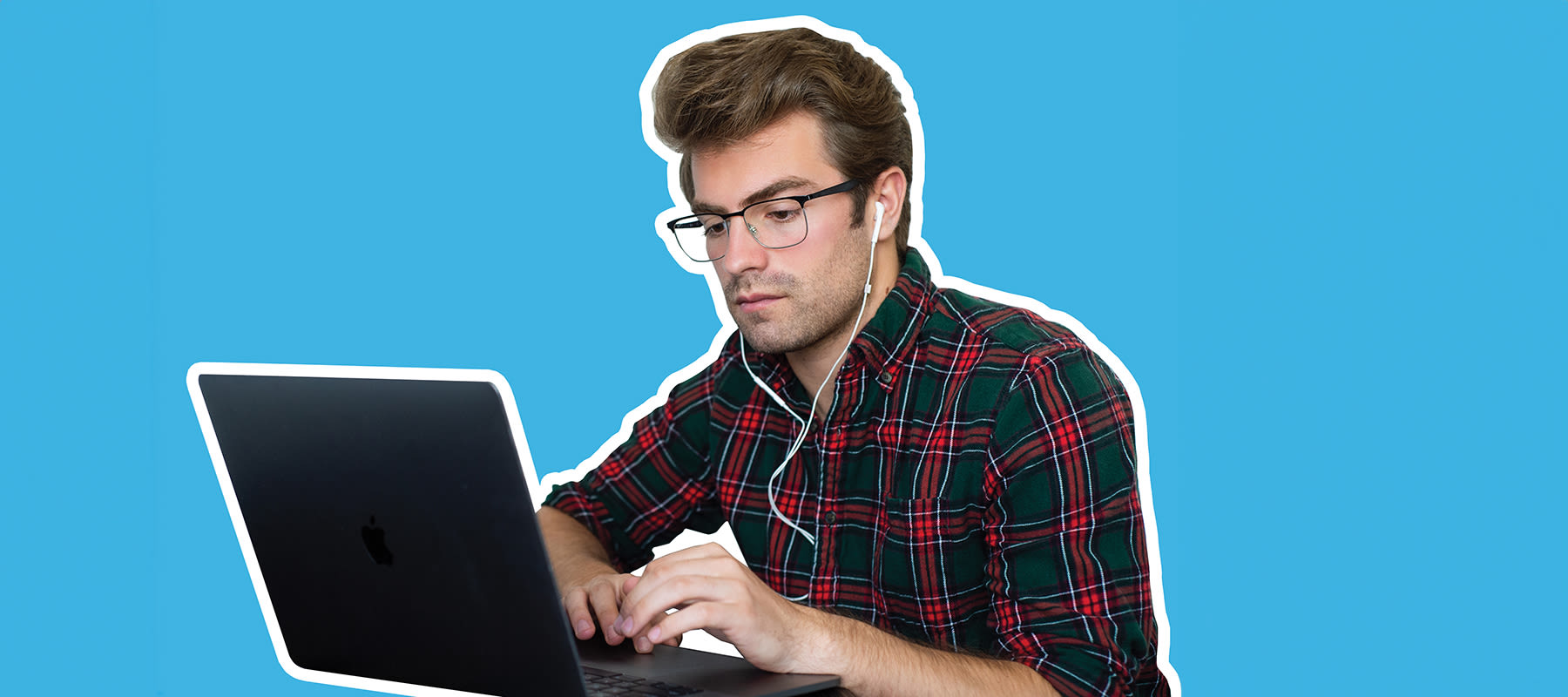 will witt sitting at a laptop with ear buds in and a bright blue background