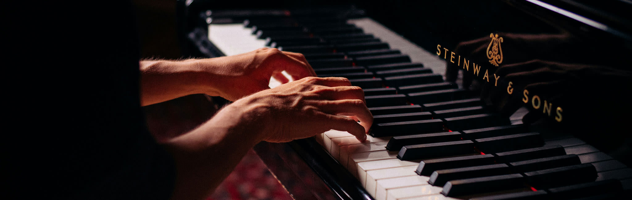pianist playing on grand piano