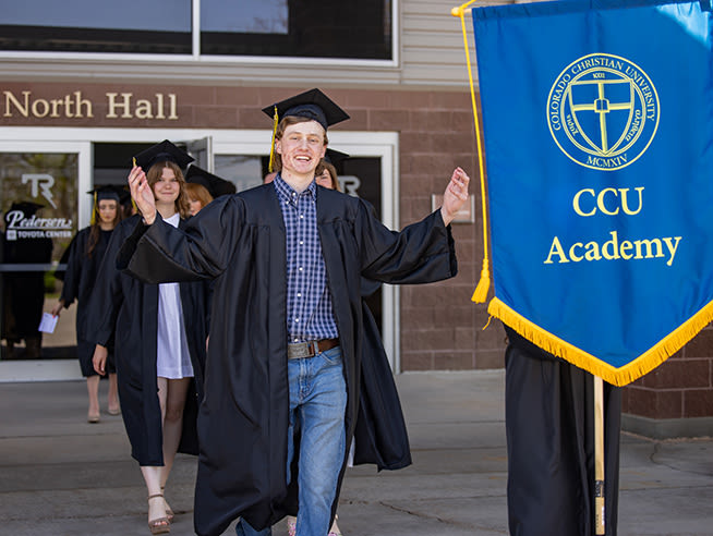 A CCU Academy student smiles at commencement