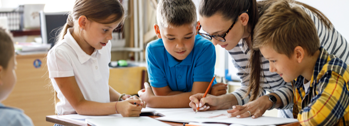 Teacher with three young students