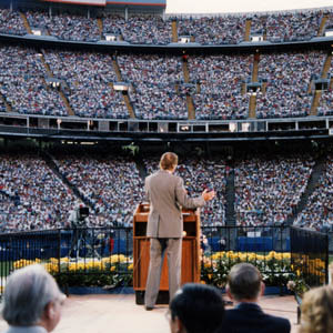 Billy Graham in front of Denverites at Mile High Stadium