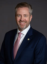 wil armstrong wearing a suit and smiling