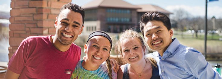 students as they smile on CCU campus during the day