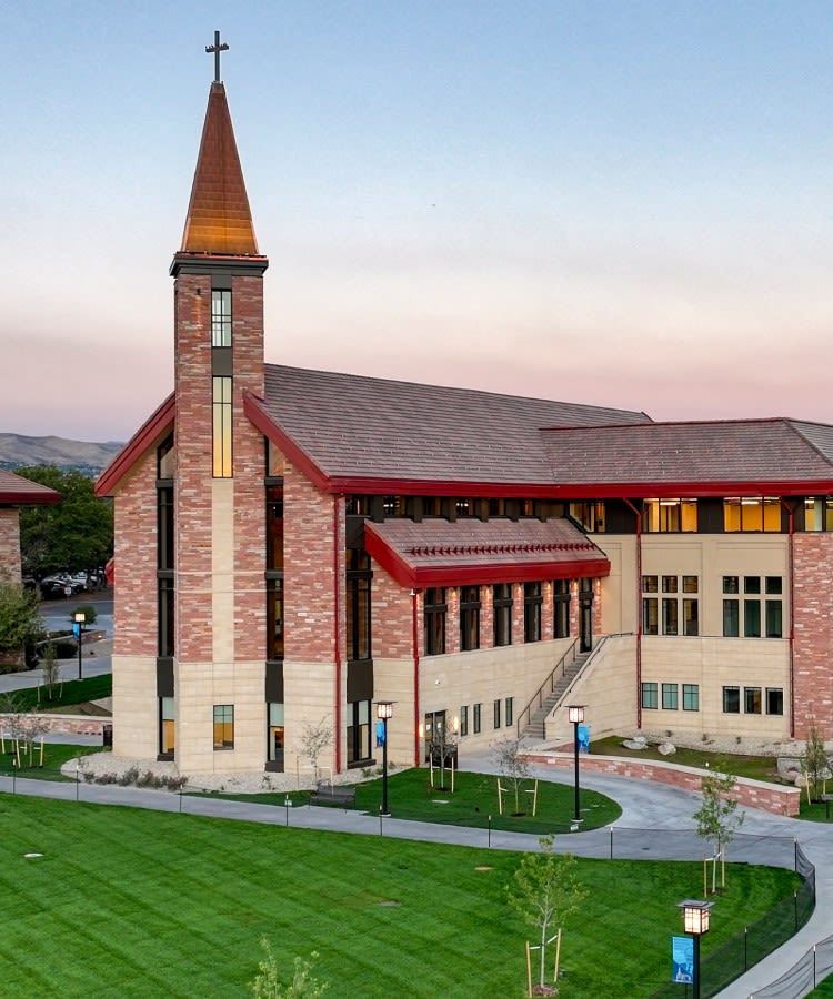 Armstrong Center building as it nears completion, with dark green turf in the foreground.