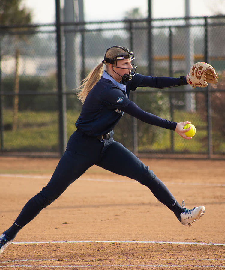 softball player pitching at a ccu game