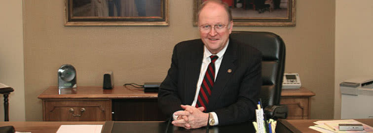 Bill Armstrong sitting at desk in office