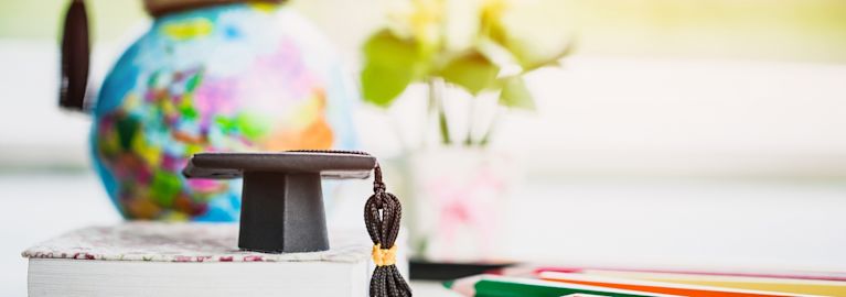a graduation cap on a notebook