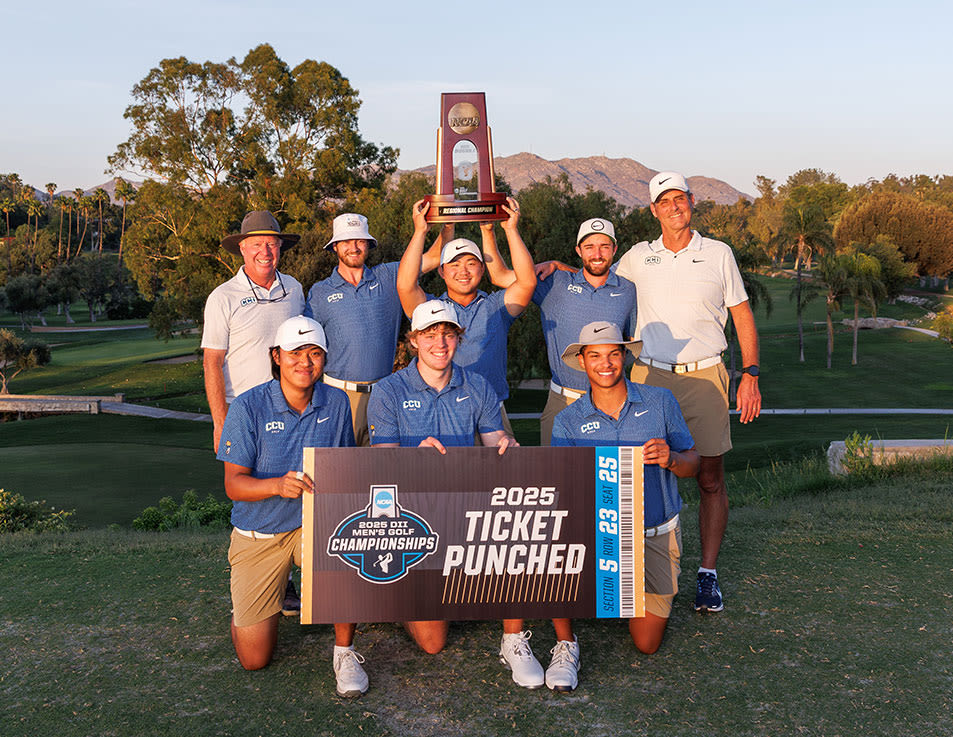 golf team holding up trophy