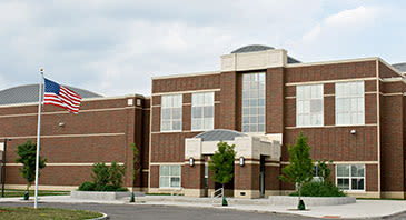 Exterior shot of a large, brick high school building.