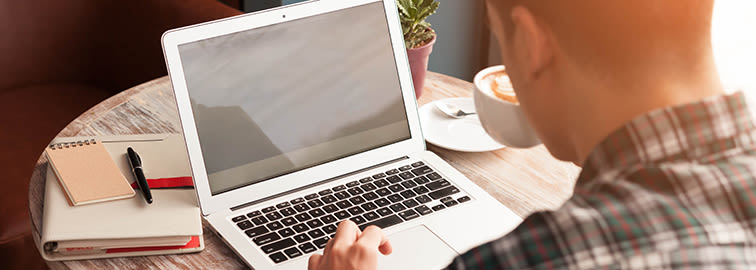 An adult student using a laptop