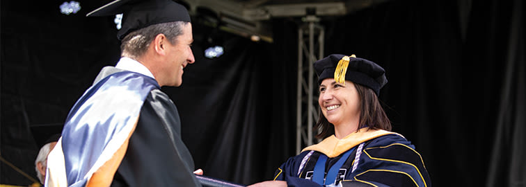 DNP graduate receiving diploma at CCU Commencement
