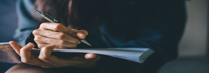 women writing in notepad