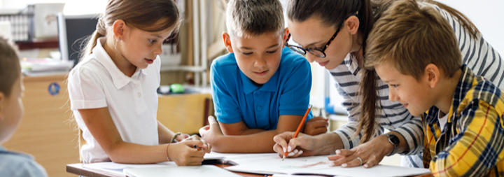 Teacher with three young students
