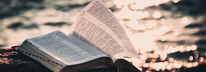 Bible on rock by the water